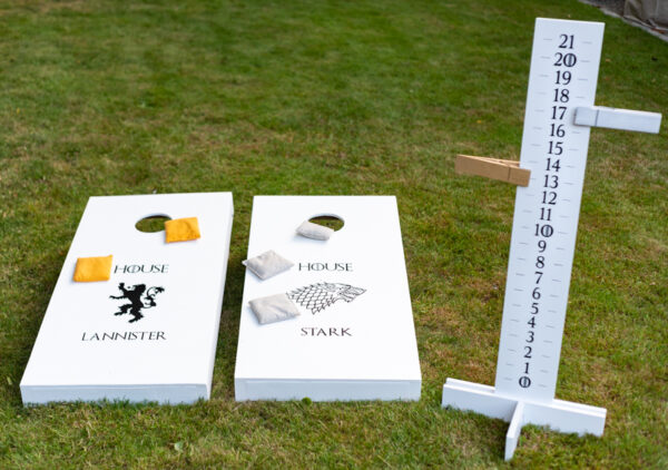 two cornhole boards with scoreboard