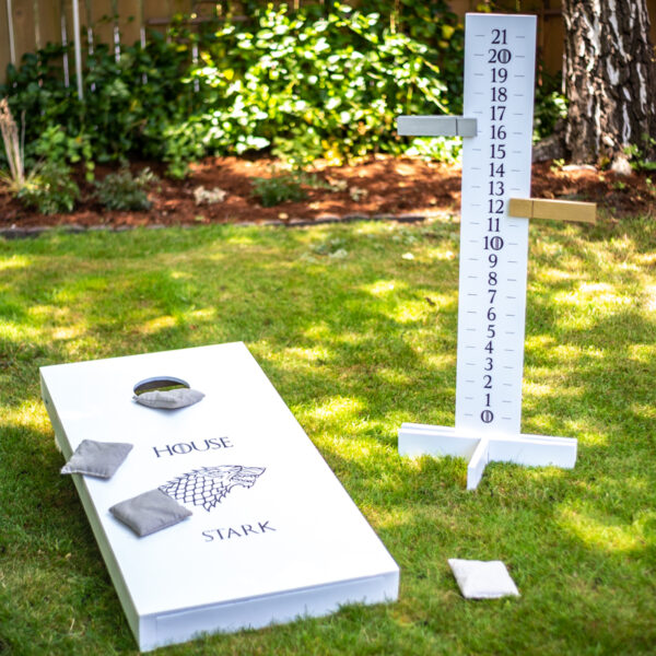 cornhole board with scoreboard on green grass